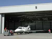 This custom pre-engineered steel hanger building is leased as a large Custom Corporate Jet service and maintenance center.  It is designed for a 100' wide by 24' high, custom stacking door system.