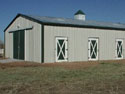  This cute little 30 x 50 Armor Steel horse barn features a double sliding door, custom stall doors and a 2' x 2' Copula.  The beautiful Fern Green trim accentuates the 40-year warranty beige colored walls very nicely.