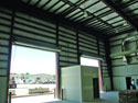Armor Steel Buildings can be designed for many overhead doors across the same end wall where standard cable bracing is not allowed.  Note the Rigid steel frame end wall, which allows multiple openings on the same end.