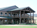 This magnificent Equestrian facility in Colorado was completed for State Senator Weins, 2000 acre Ranch.  The front of the Armor steel Building boasts a beautiful log & Rock front with a 2-story office Mezzanine that overlooks the interior arena. This facility is often used for the Children's Hospital, Buckaroo Ball and other Charity events.